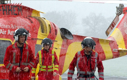 Medics in front of an air ambulance helicopter